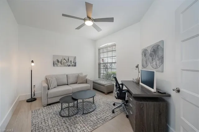 a view of a livingroom with workspace and a couch