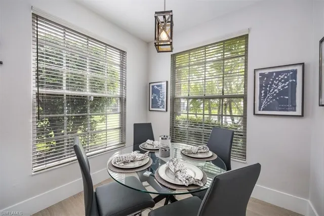 a view of a dining room with furniture large windows and wooden floor