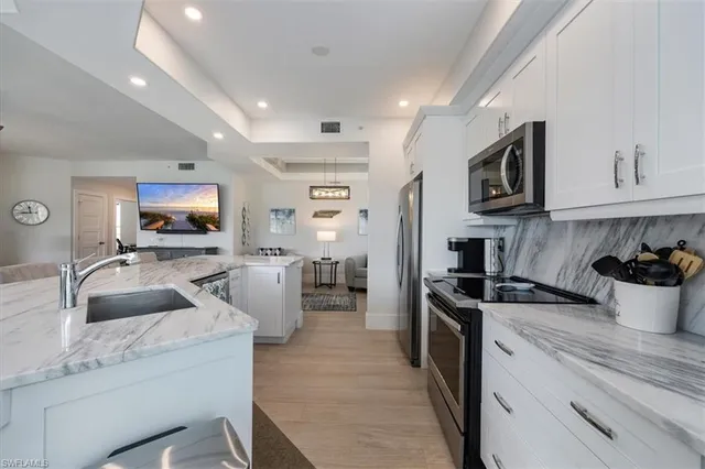 a kitchen with granite countertop a sink and appliances