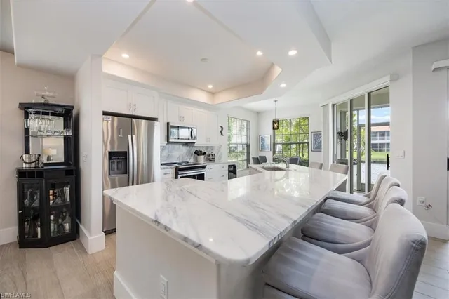 a living room with furniture a large window and gym equipment