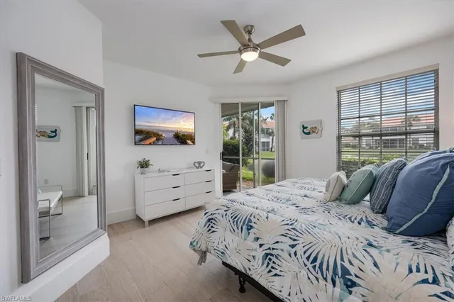 a bedroom with a bed and a large window