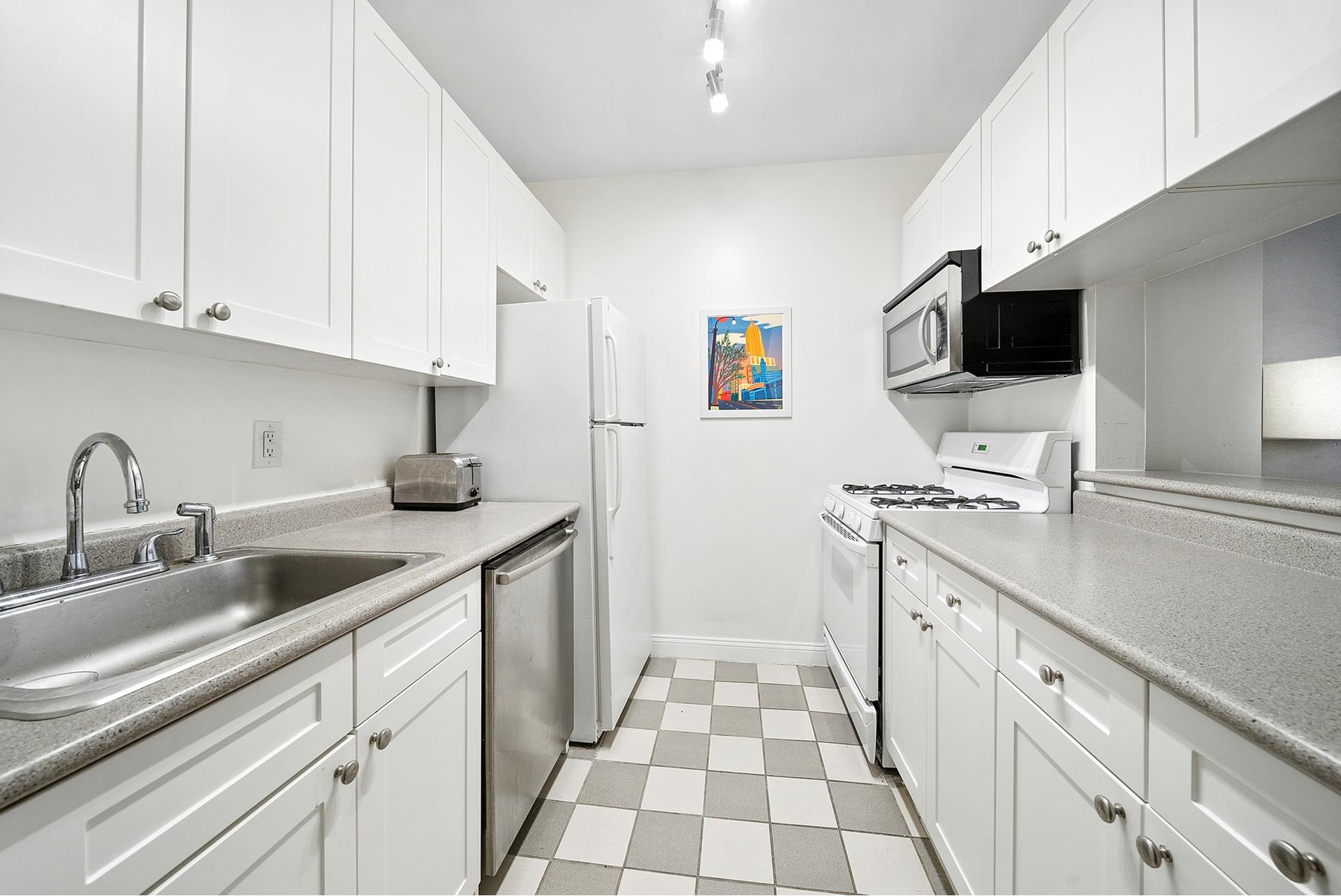 88 Greenwich Street, Unit 424 Manhattan, NY 10006 - Photo 3 of 5 a kitchen with stainless steel appliances granite countertop a sink and a stove