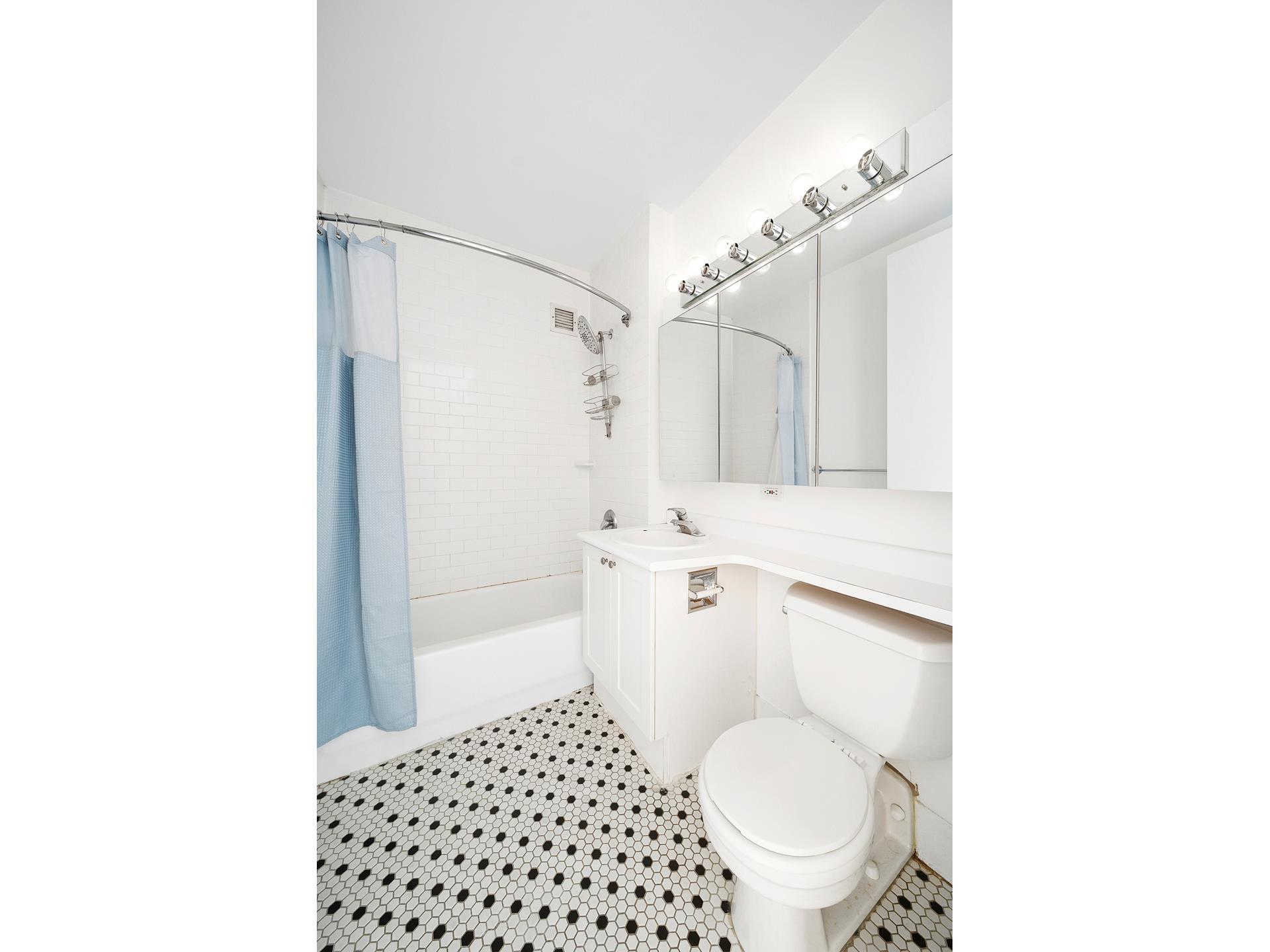 88 Greenwich Street, Unit 424 Manhattan, NY 10006 - Photo 5 of 5 a bathroom with a sink toilet and shower
