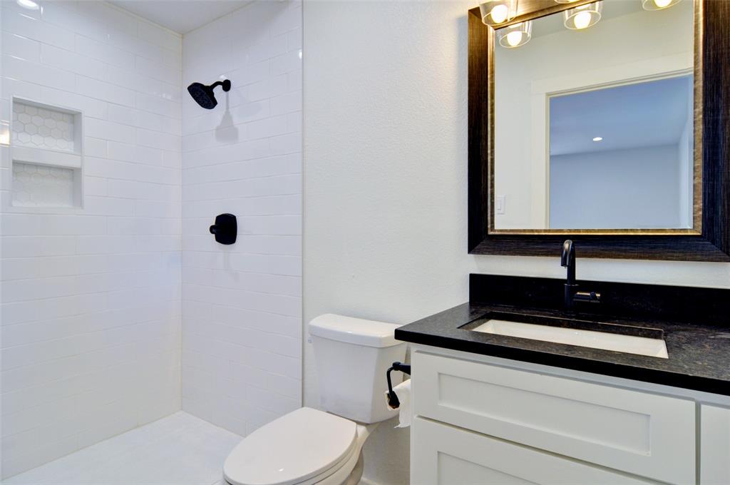 5549 Sam Calloway Road Fort Worth, TX 76114 - Photo 22 of 31 a bathroom with a sink a toilet and a mirror
