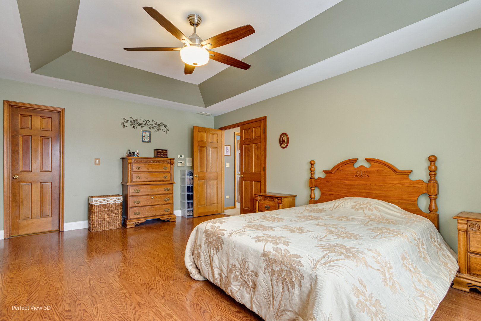 1910 Hampton Court Plainfield, IL 60586 - Photo 19 of 36 a bedroom with a bed and a chandelier