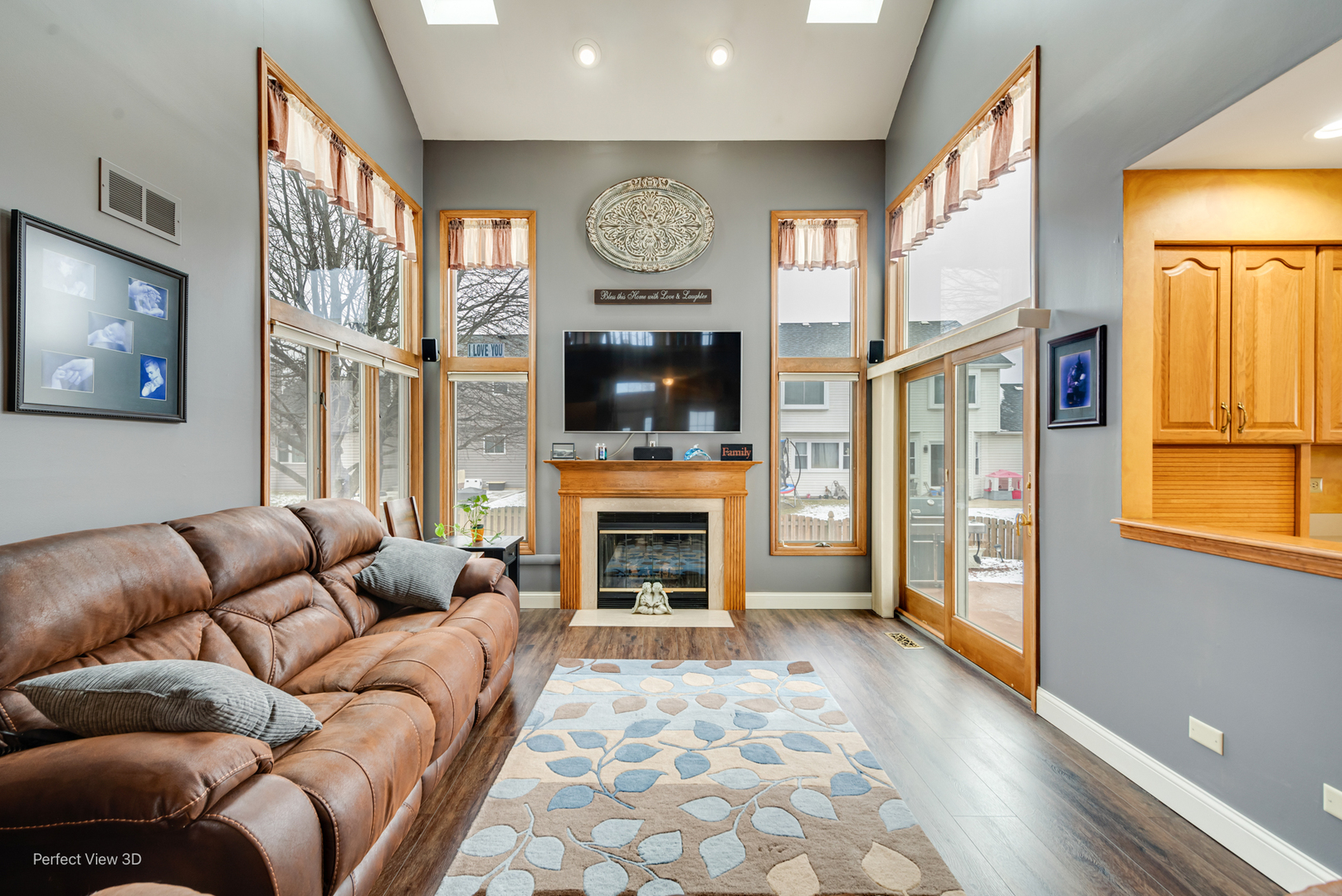 1910 Hampton Court Plainfield, IL 60586 - Photo 9 of 36 a living room with furniture a fireplace and a flat screen tv