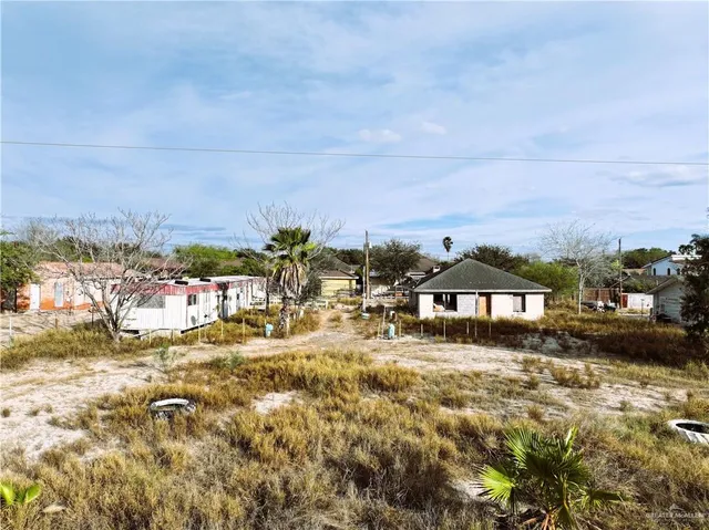 a view of a big yard with an ocean view