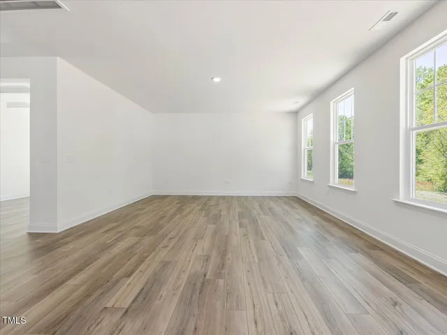 a kitchen with granite countertop stainless steel appliances a stove sink and cabinets