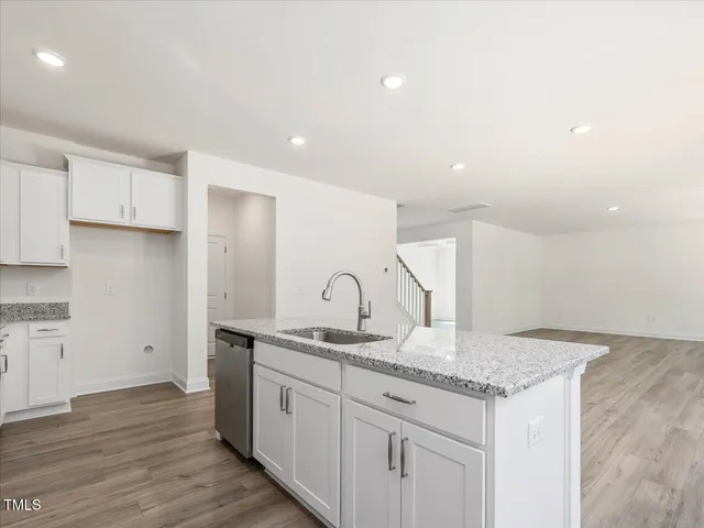 a bathroom with a double vanity sink mirror and bathtub