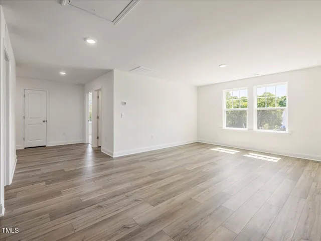 an aerial view of ocean and residential houses with outdoor space