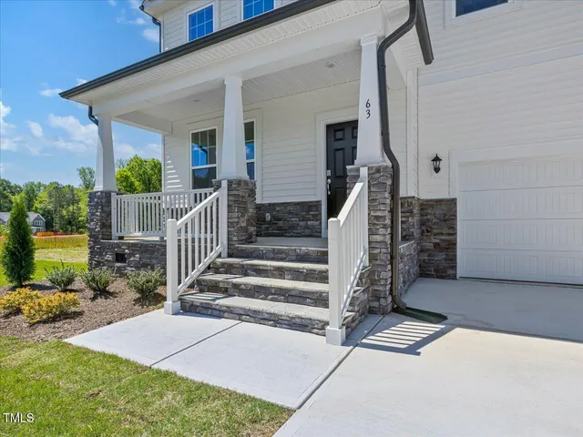 a view of a hallway with wooden floor and entryway