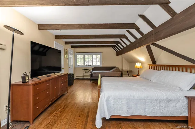 a bedroom with furniture and a flat screen tv