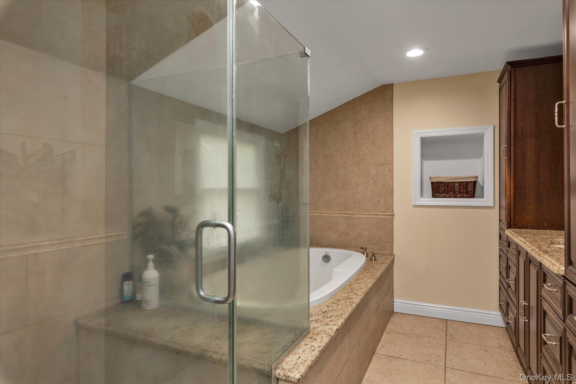 2177 Cedar Swamp Road Glen Head, NY 11545 - Photo 13 of 18 a bathroom with a tub and shower