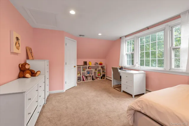 a view of a bedroom with workspace and windows