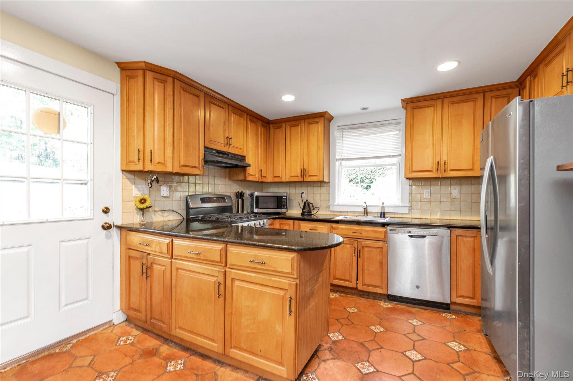 2177 Cedar Swamp Road Glen Head, NY 11545 - Photo 5 of 18 a kitchen with stainless steel appliances granite countertop wooden cabinets sink and a granite counter top