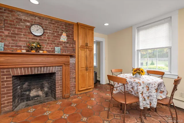 a dining room with furniture and a fireplace