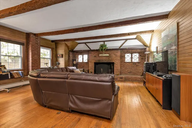 a living room with furniture a large window and a fireplace