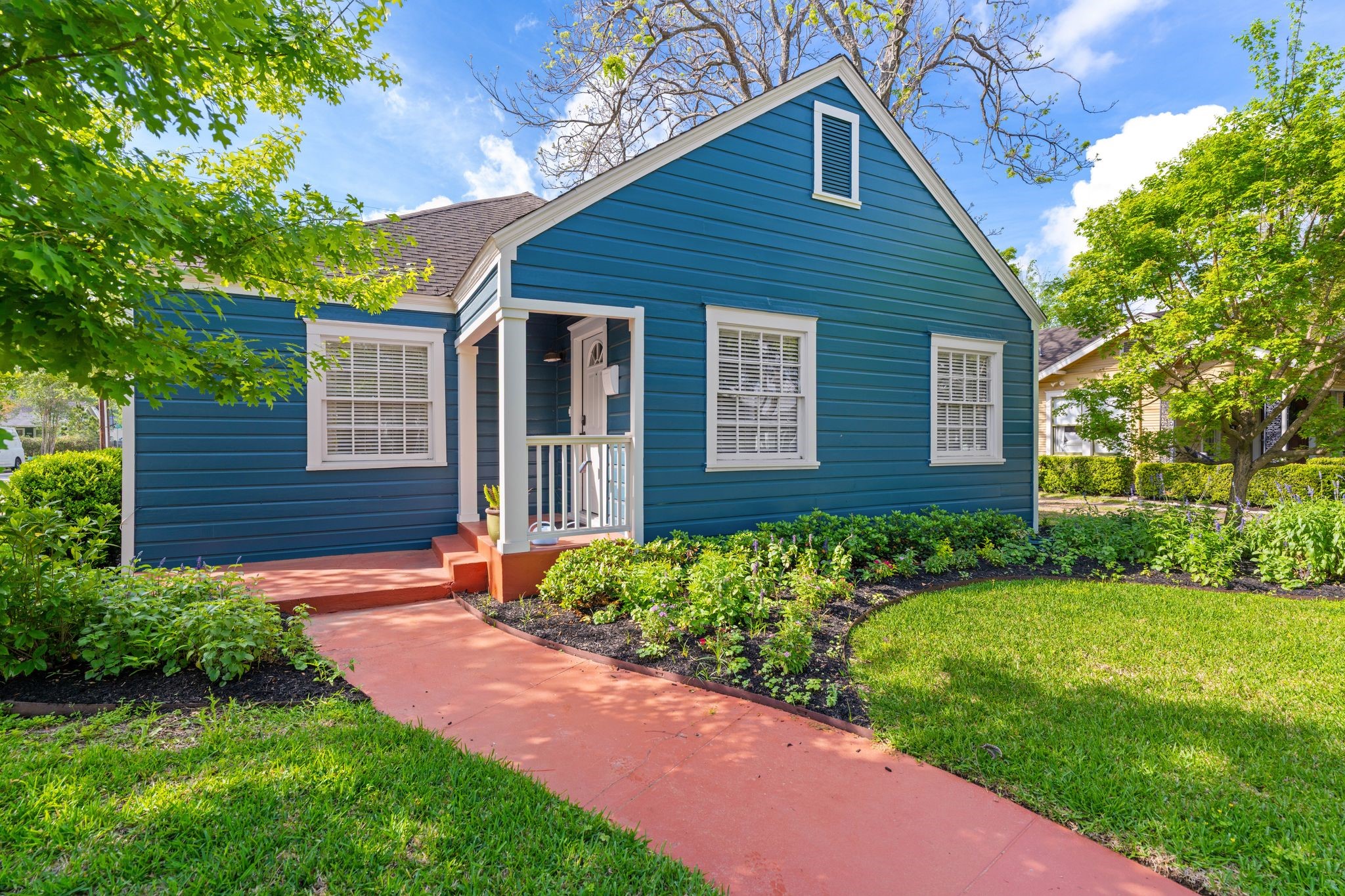 a front view of a house with garden