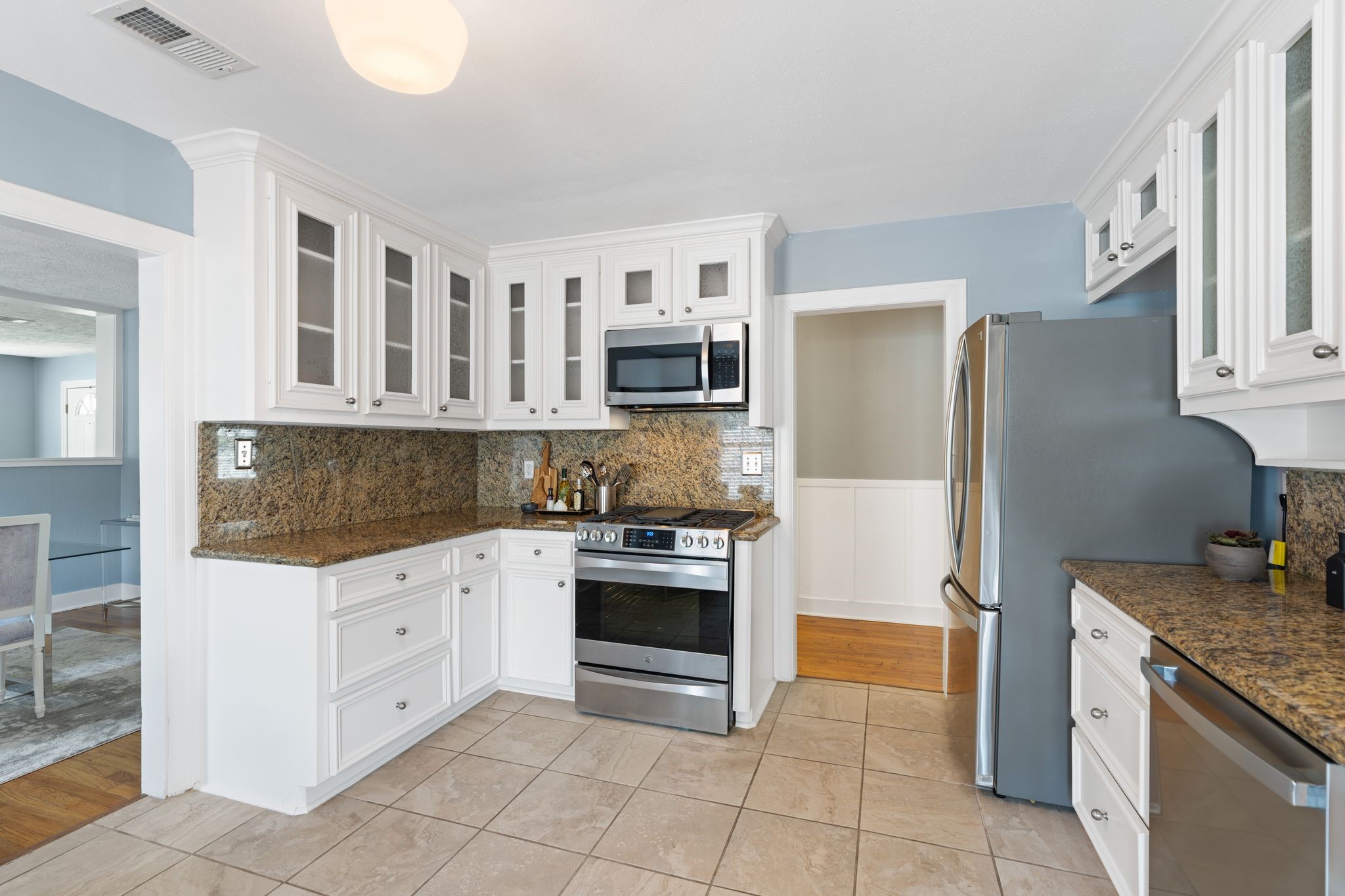 1102 Winston Street Houston, TX 77009 - Photo 12 of 30 a kitchen with granite countertop a stove top oven and refrigerator