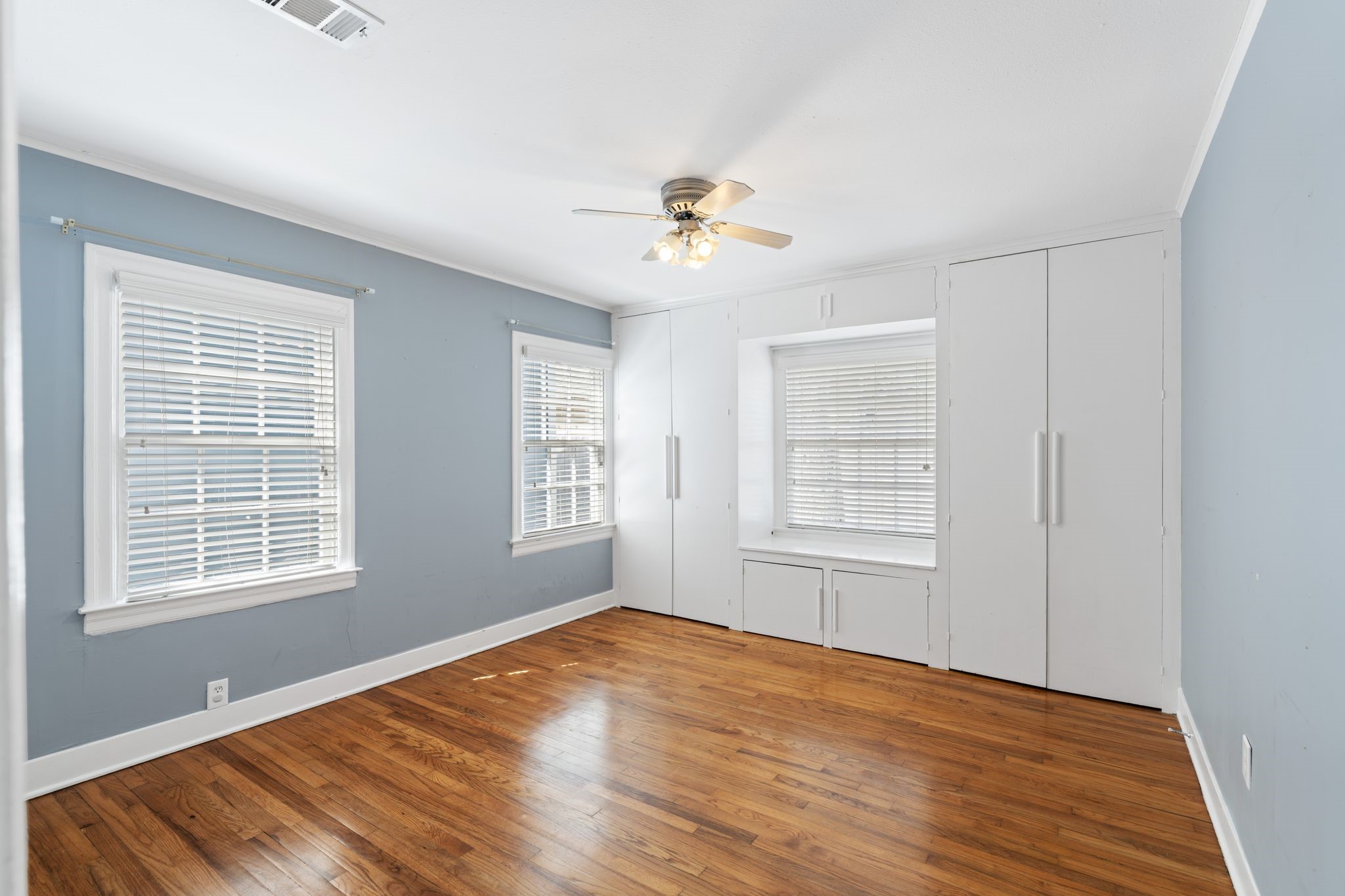 1102 Winston Street Houston, TX 77009 - Photo 19 of 30 a view of empty room with wooden floor and fan