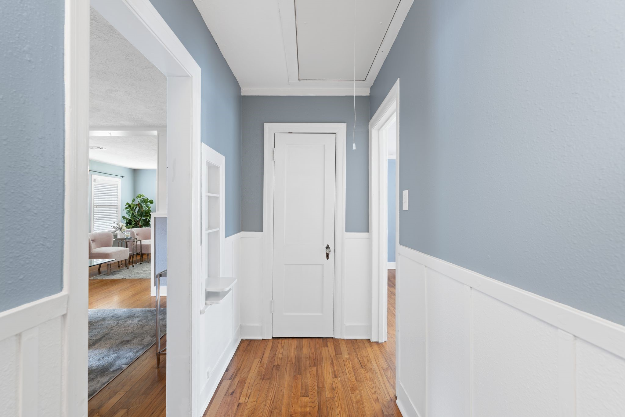 1102 Winston Street Houston, TX 77009 - Photo 22 of 30 a view of a hallway with wooden floor and a living room