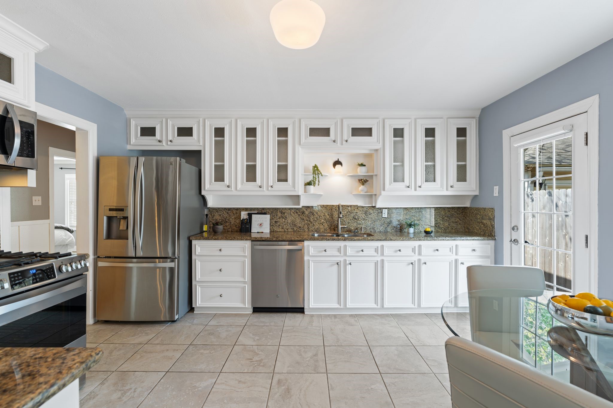 1102 Winston Street Houston, TX 77009 - Photo 4 of 30 a kitchen with granite countertop a refrigerator stove top oven and sink