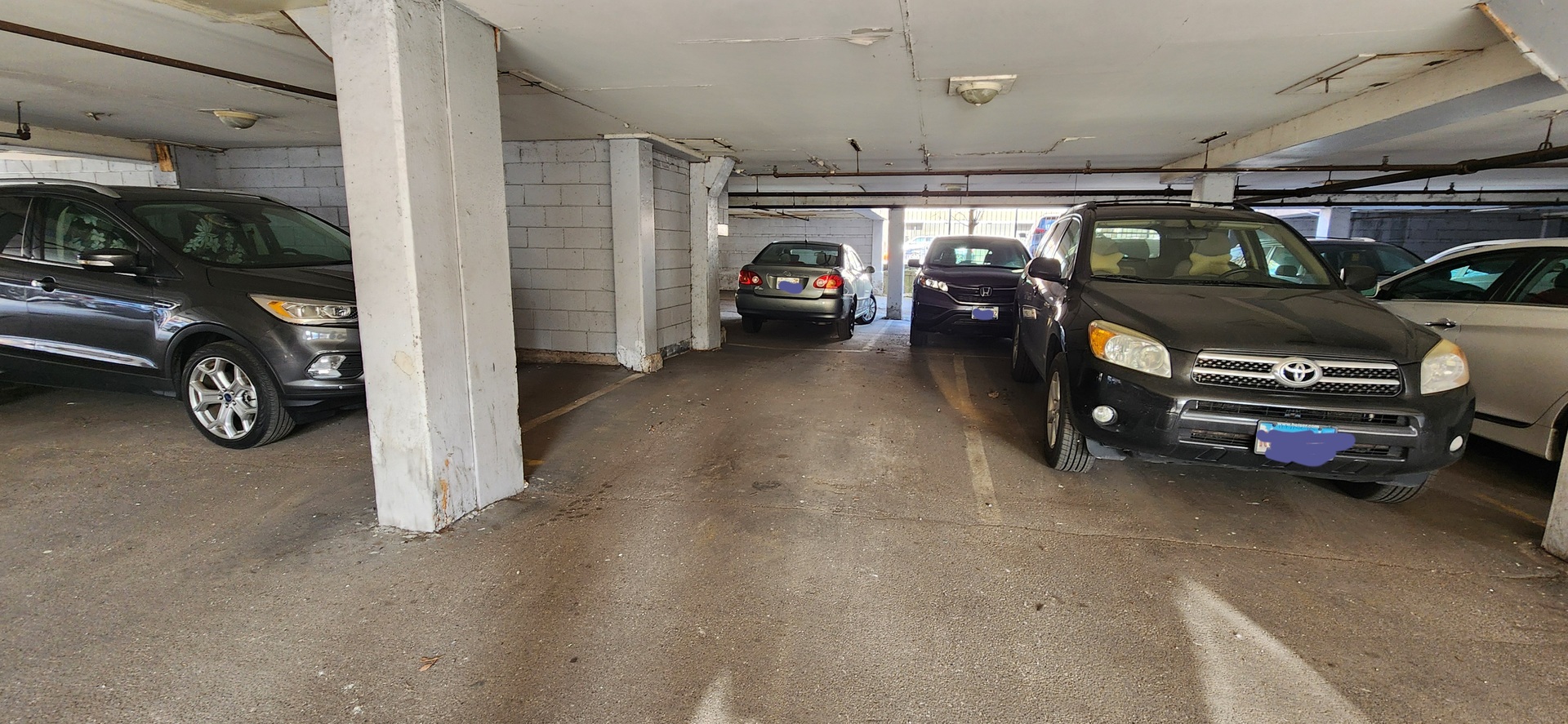 5100 North Sheridan Road, Unit 509 Chicago, IL 60640 - Photo 16 of 16 a view of parking garage with cars parked