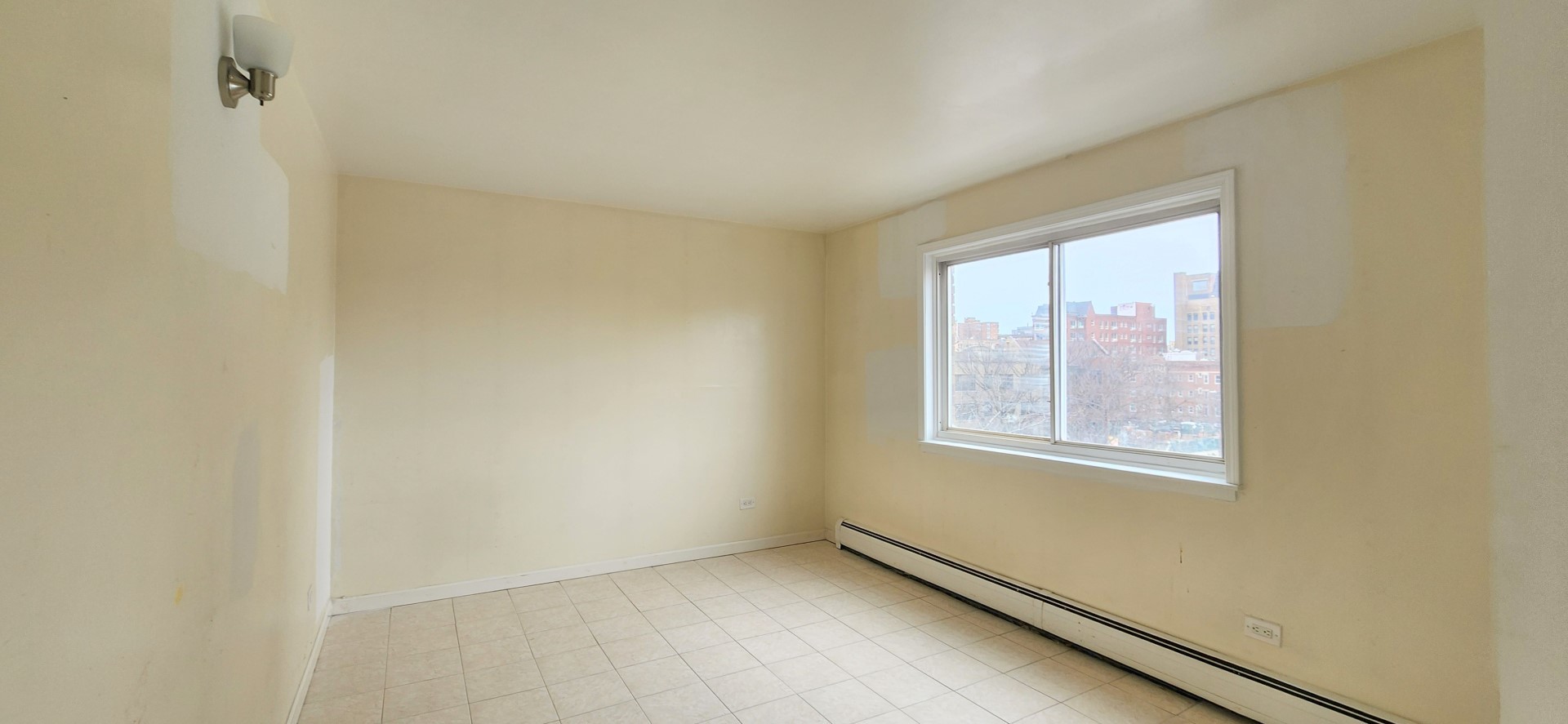 5100 North Sheridan Road, Unit 509 Chicago, IL 60640 - Photo 8 of 16 an empty room with windows
