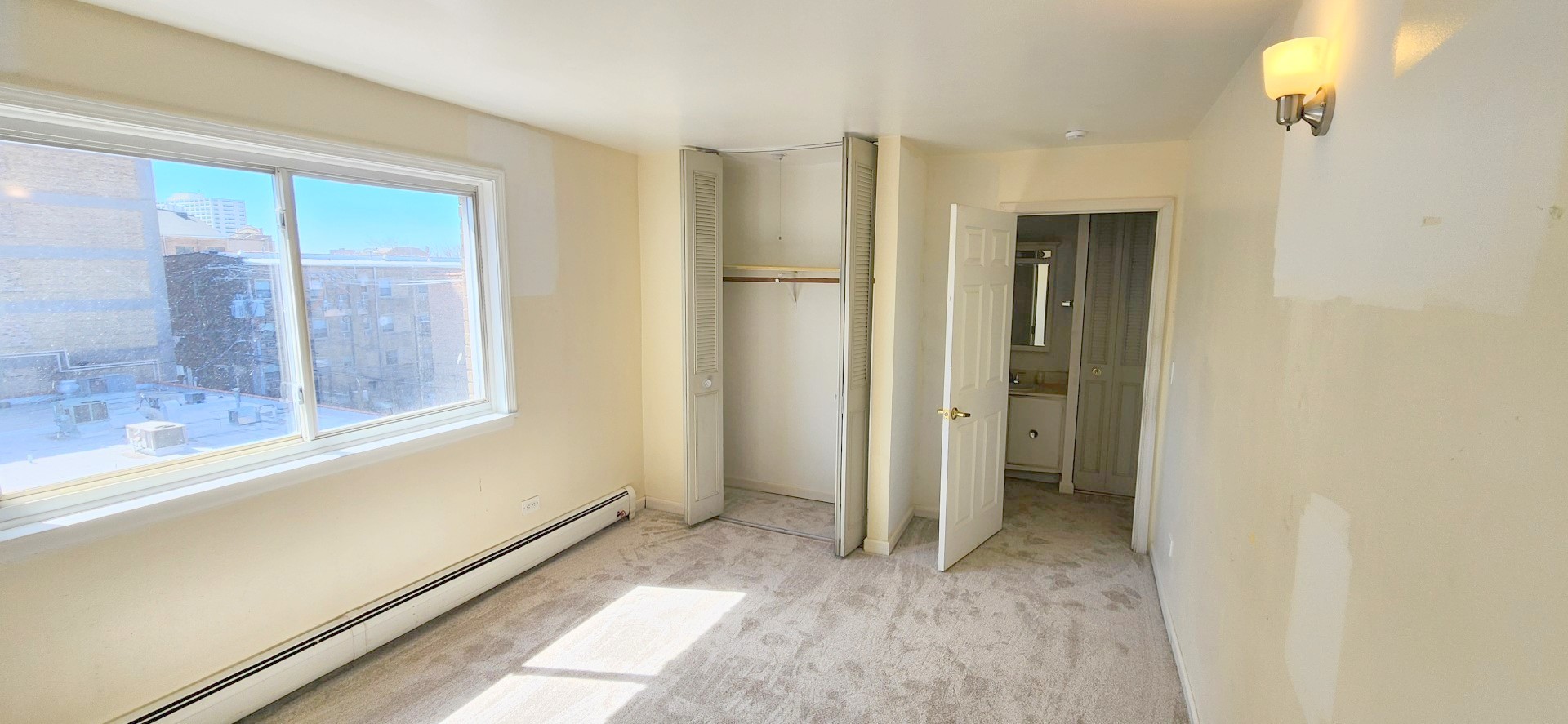 5100 North Sheridan Road, Unit 509 Chicago, IL 60640 - Photo 10 of 16 a view of an empty room with a window