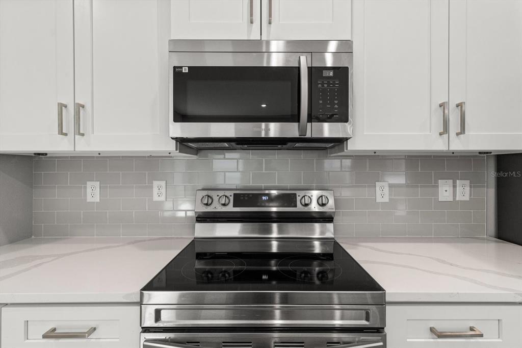 9 Fringetree Street Homosassa, FL 34446 - Photo 14 of 37 a kitchen with stainless steel appliances granite countertop a stove and a microwave