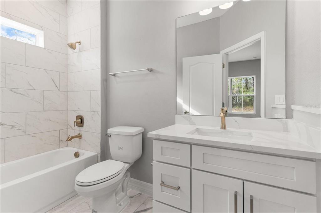 9 Fringetree Street Homosassa, FL 34446 - Photo 29 of 37 a bathroom with a sink a toilet and shower