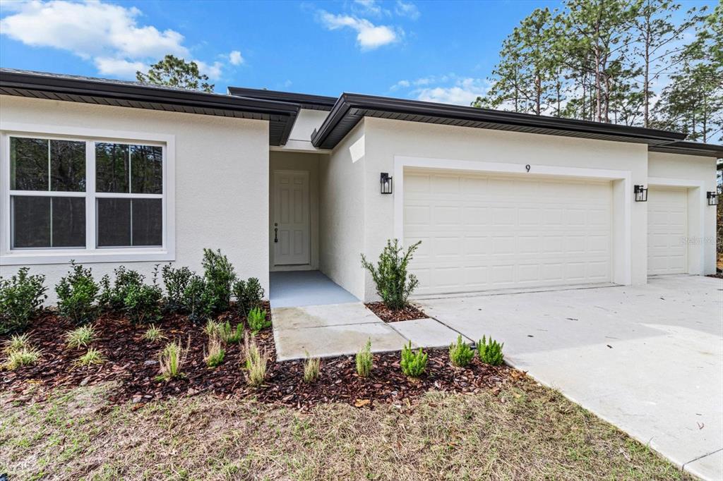 9 Fringetree Street Homosassa, FL 34446 - Photo 6 of 37 a front view of a house with garden