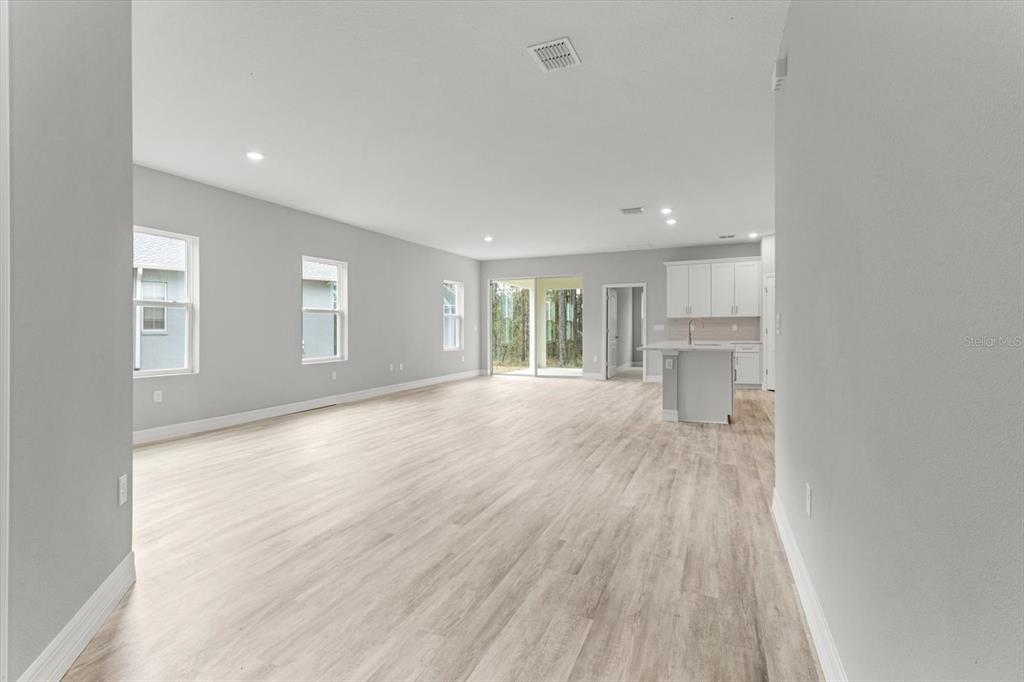 9 Fringetree Street Homosassa, FL 34446 - Photo 8 of 37 a view of empty room with wooden floor and kitchen