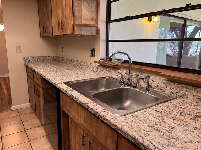 a view of a room with window ceiling fan and stairs