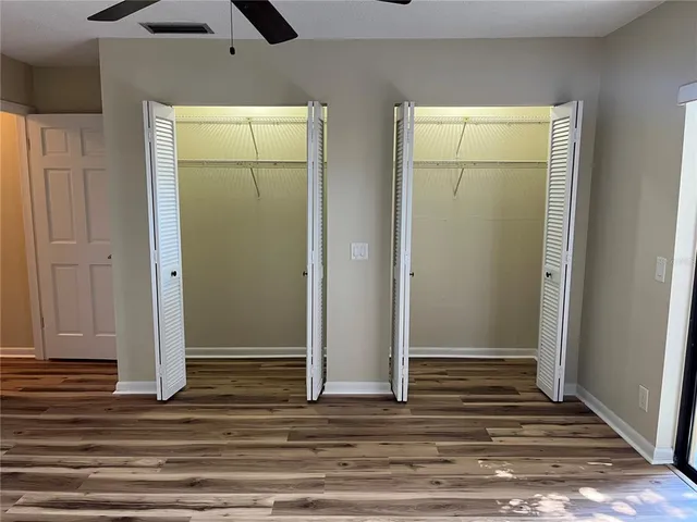 a view of a room with wooden floor and door