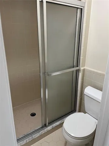 a bathroom with a glass shower door