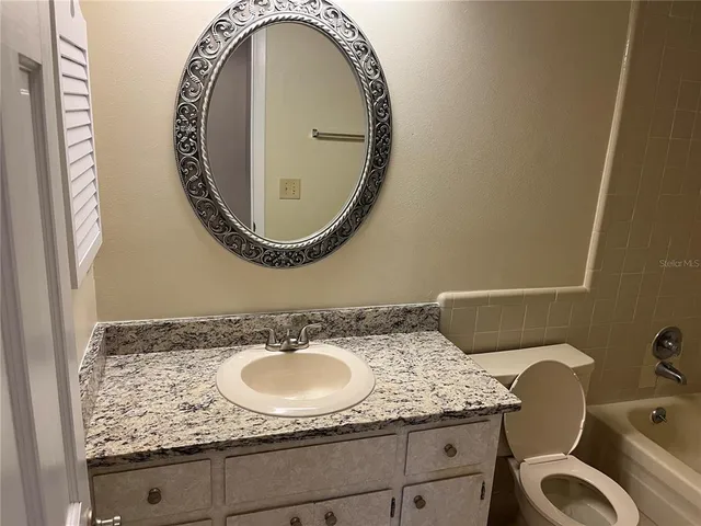 a bath tub sitting next to a white sink