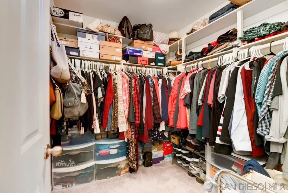 8713 Glen Oaks Way Santee, CA 92071 - Photo 12 of 22 a view of walk in closet with clothes and shoes