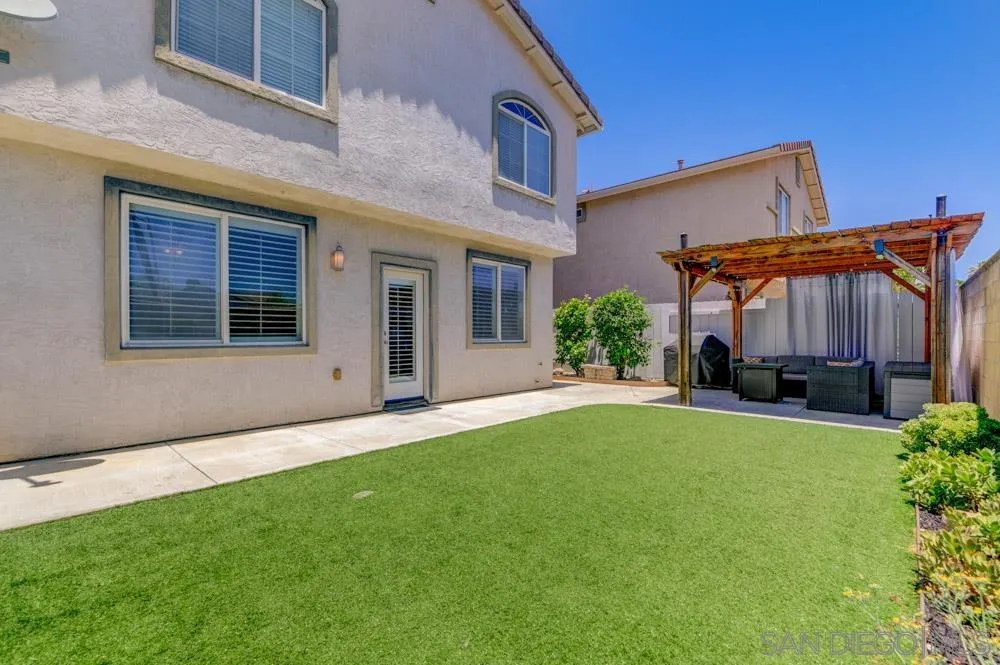 8713 Glen Oaks Way Santee, CA 92071 - Photo 18 of 22 a front view of a house with a yard and garage