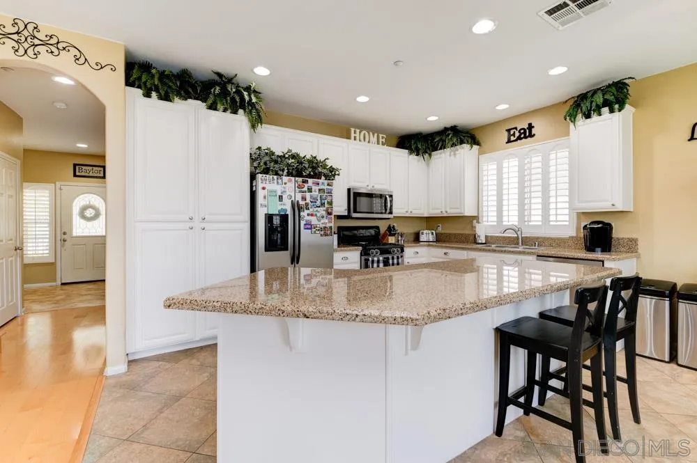 8713 Glen Oaks Way Santee, CA 92071 - Photo 2 of 22 a kitchen with stainless steel appliances granite countertop a stove a sink and a refrigerator