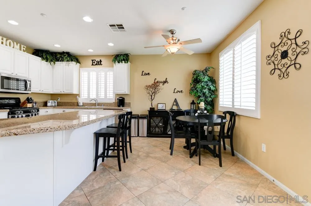 8713 Glen Oaks Way Santee, CA 92071 - Photo 5 of 22 a view of a dining room with furniture and a chandelier