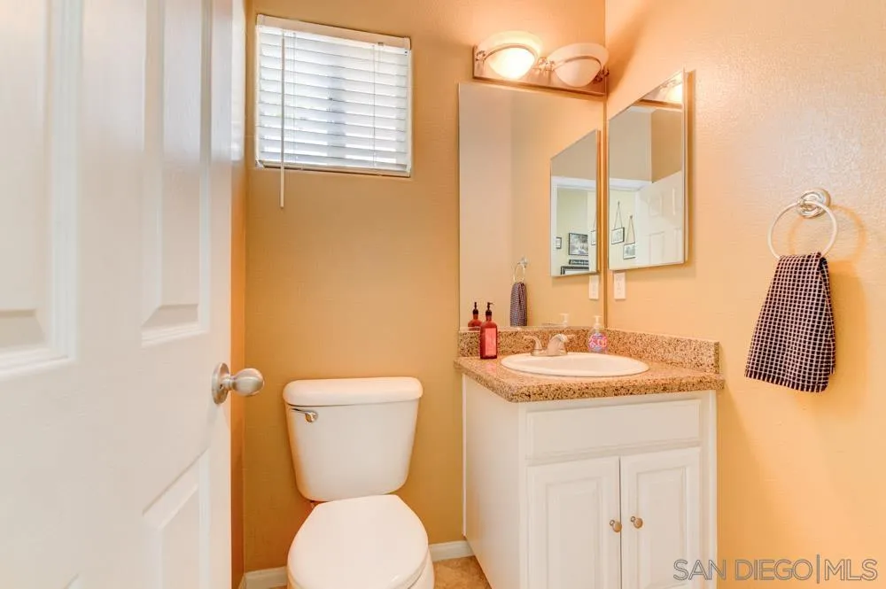 8713 Glen Oaks Way Santee, CA 92071 - Photo 6 of 22 a bathroom with a toilet sink and mirror