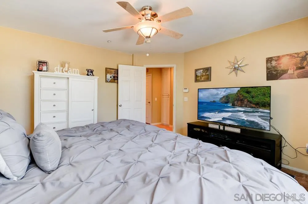 8713 Glen Oaks Way Santee, CA 92071 - Photo 10 of 22 a bedroom with a bed and a painting on the wall