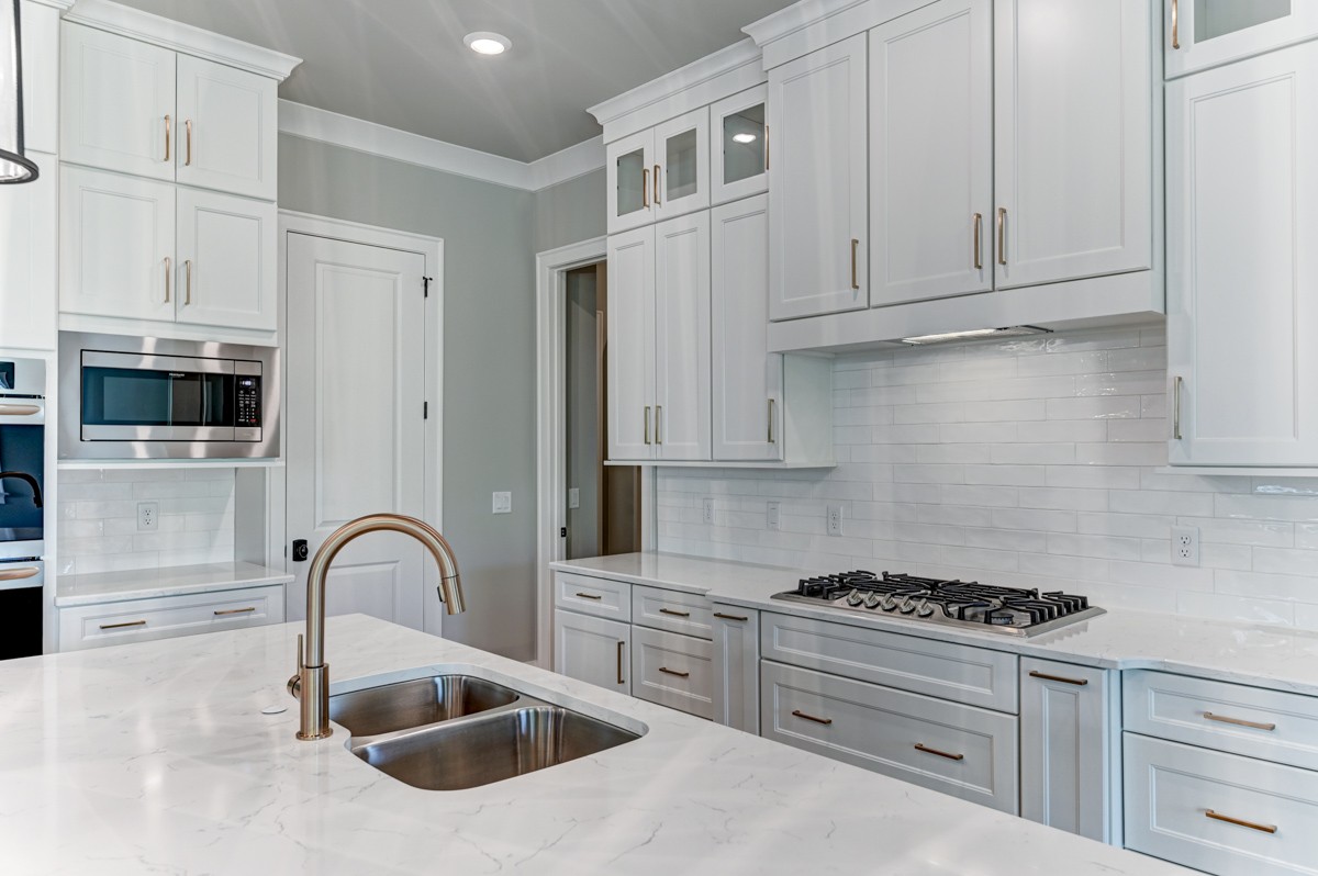 237 Circuit Road Franklin, TN 37064 - Photo 17 of 47 a kitchen with stainless steel appliances granite countertop a stove a sink and a microwave