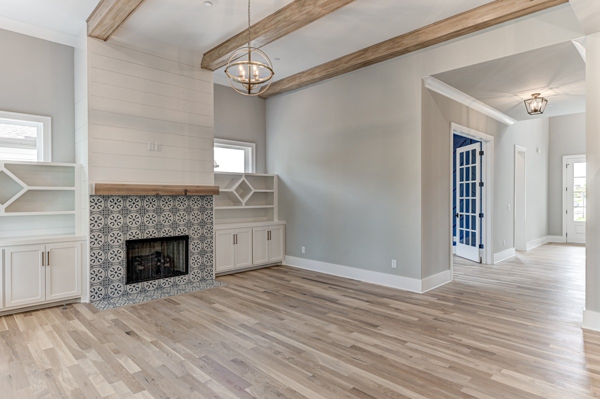 237 Circuit Road Franklin, TN 37064 - Photo 10 of 47 a view of an empty room with wooden floor fireplace and a window