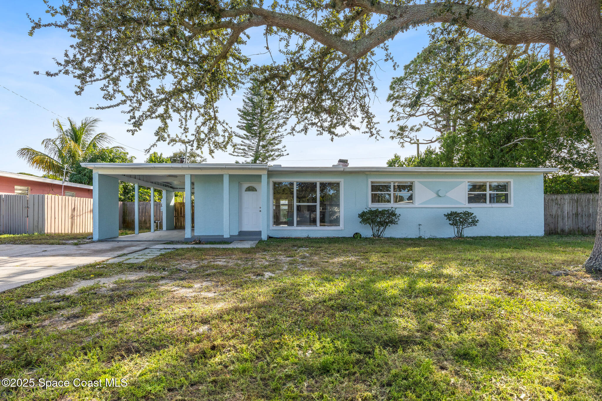 1107 Alamanda Lane Cocoa, FL 32922 - Photo 1 of 24 a view of a house with a yard and large tree
