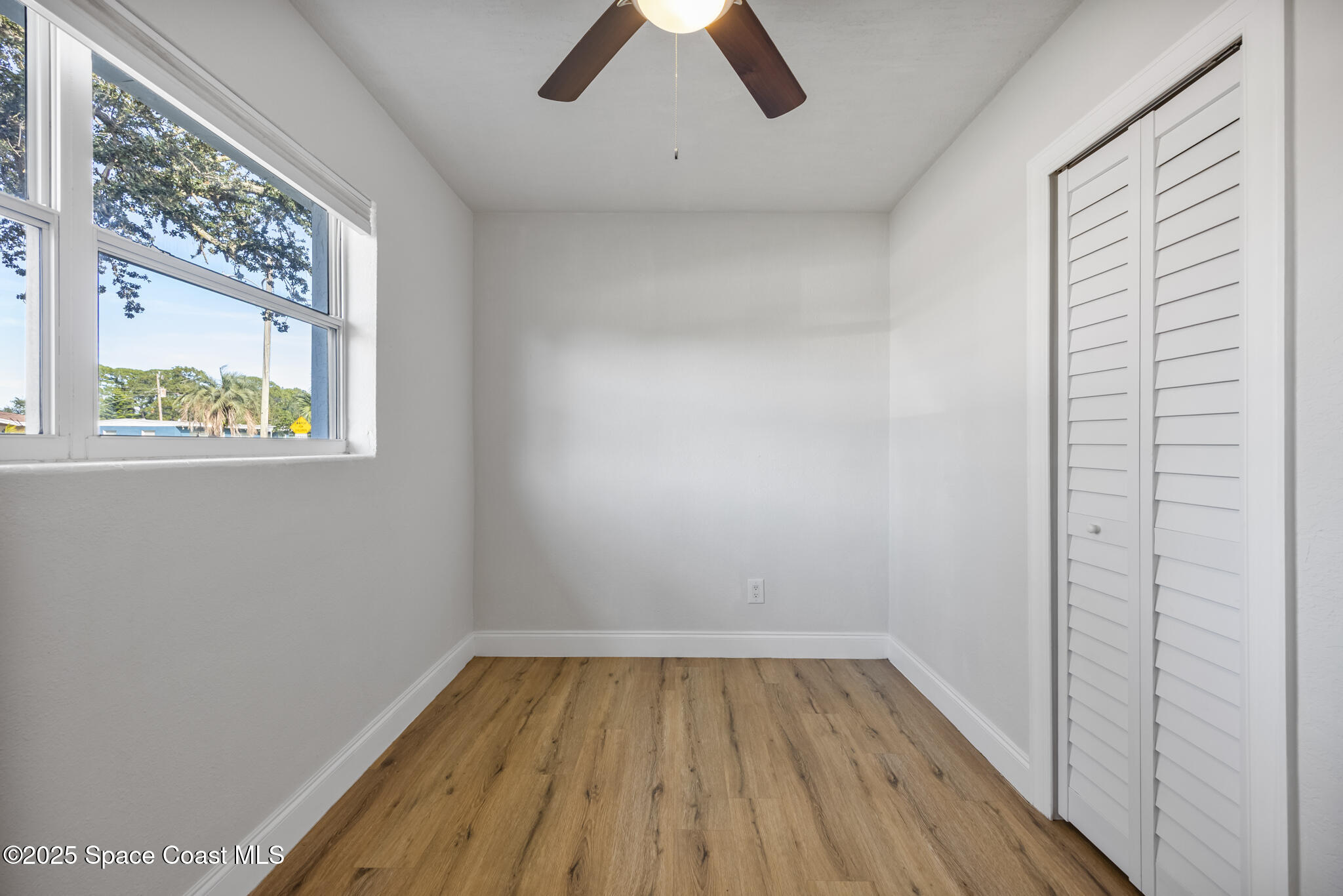 1107 Alamanda Lane Cocoa, FL 32922 - Photo 11 of 24 a view of empty room with window and wooden floor