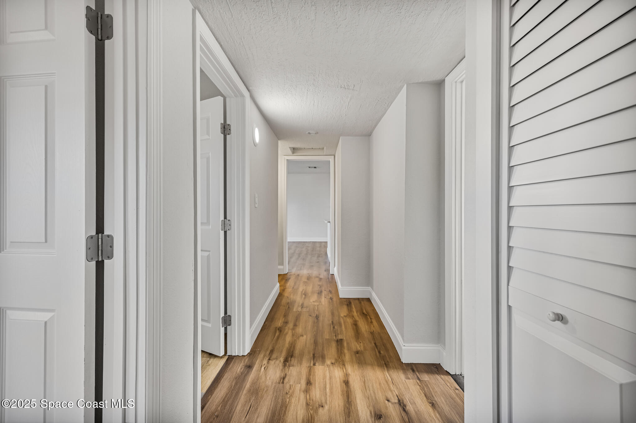 1107 Alamanda Lane Cocoa, FL 32922 - Photo 13 of 24 a view of a hallway with wooden floor and staircase