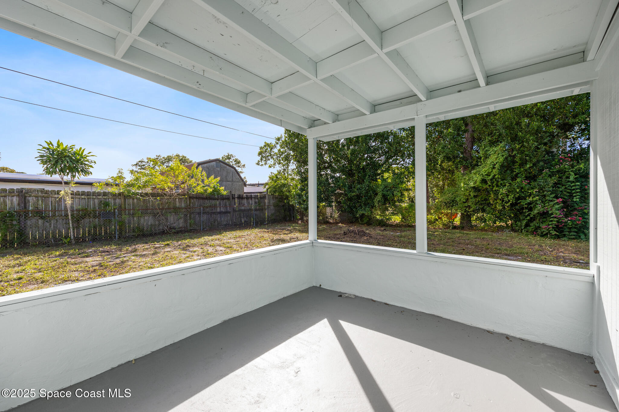 1107 Alamanda Lane Cocoa, FL 32922 - Photo 21 of 24 a view of a room with a large window and wooden floor
