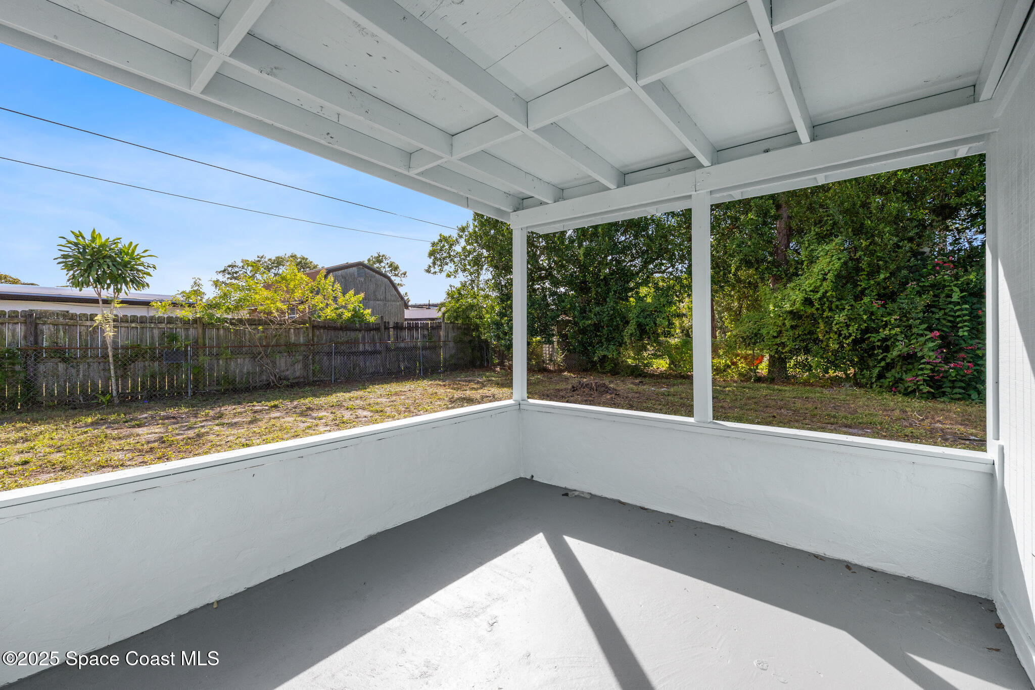 1107 Alamanda Lane Cocoa, FL 32922 - Photo 22 of 24 a view of a room with a large window and wooden floor